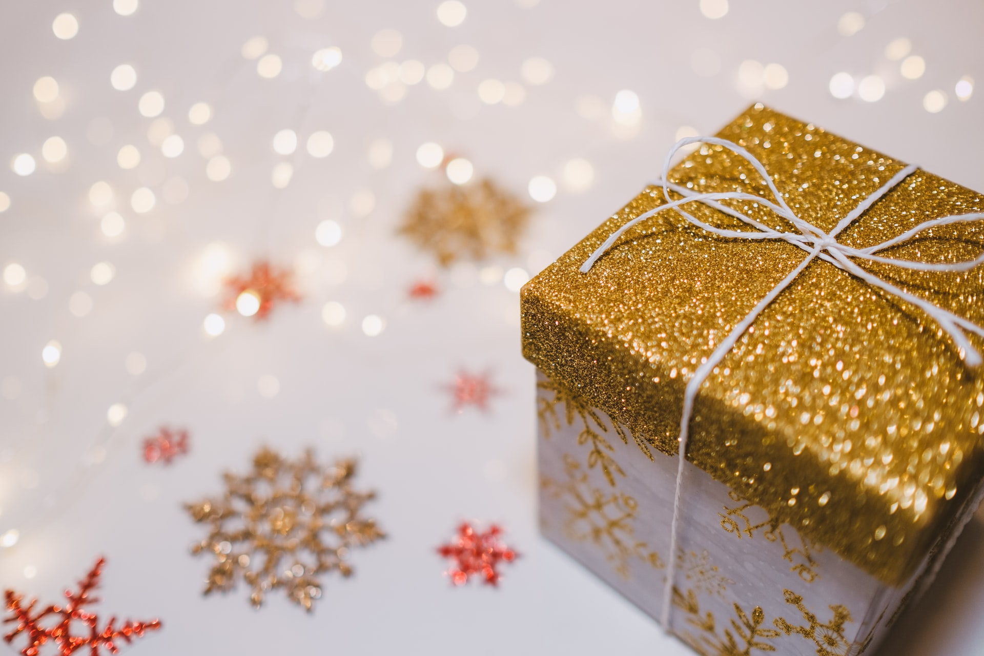 Festive holiday present box with glitter and snowflakes 