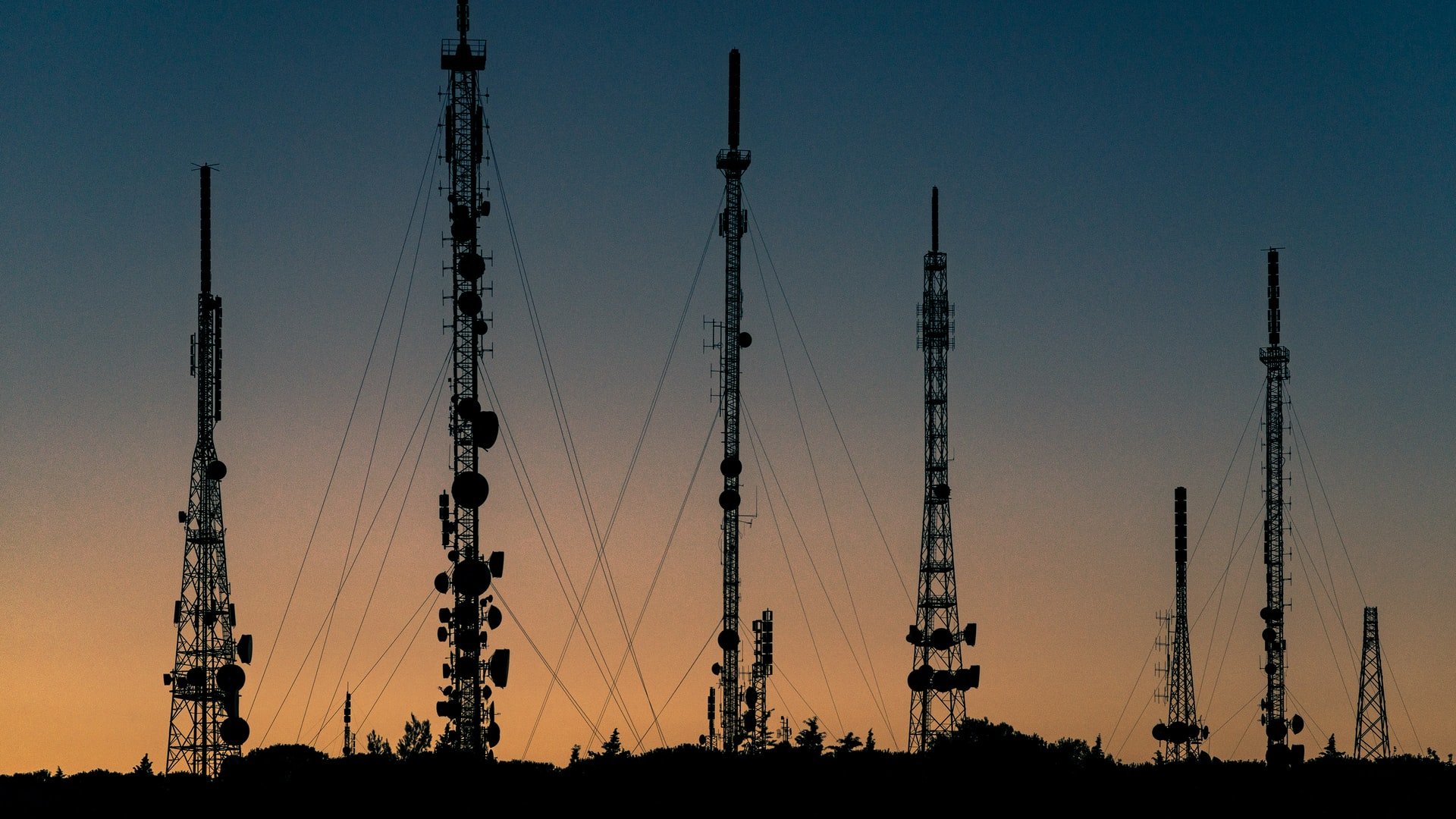 telecommunication towers at sunrise/sunset
