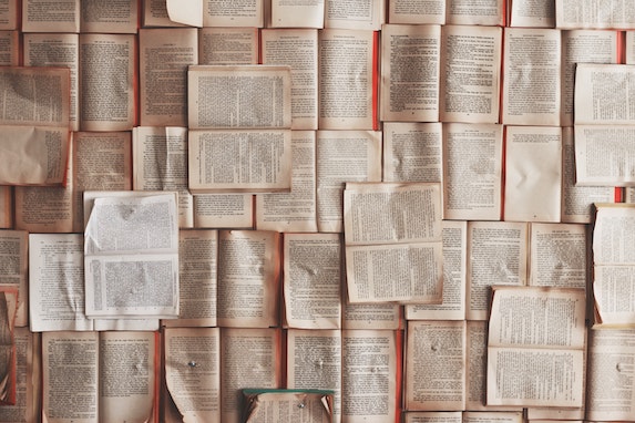 colourful books on white shelves 