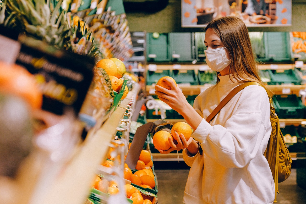 consumer making choices in a grocery store during the pandemic