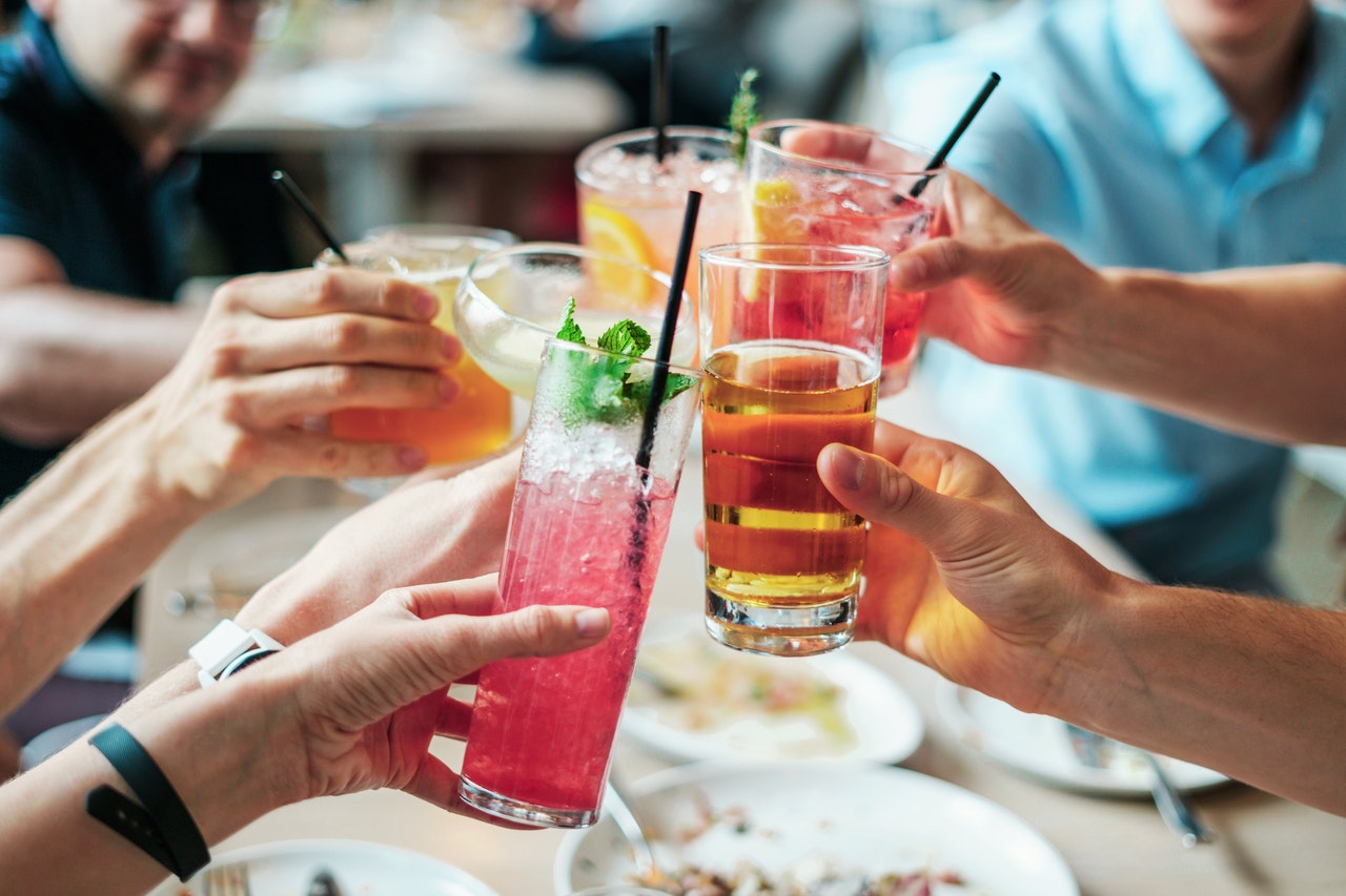 people toasting with different types of beverages