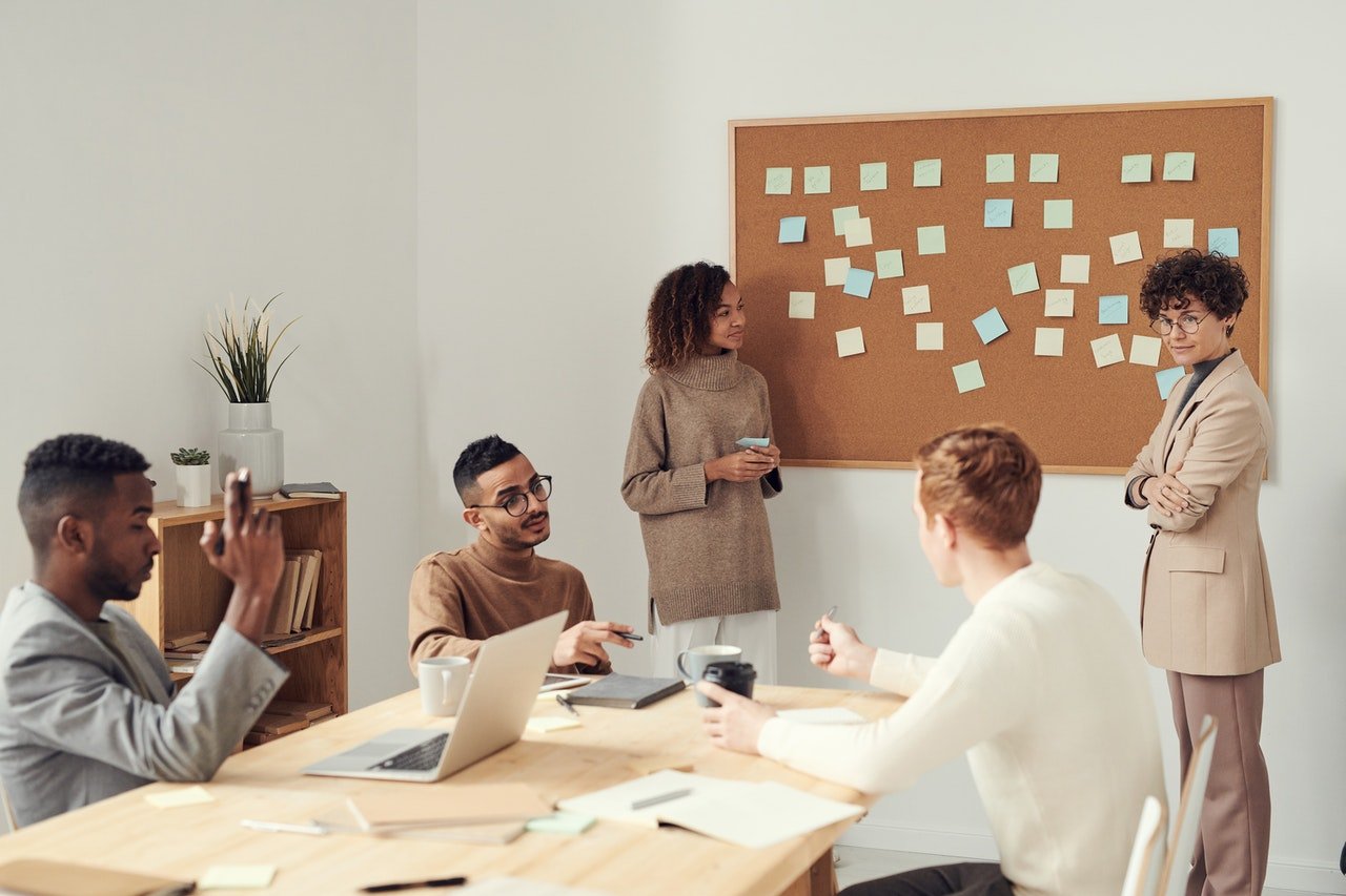 people working together at a table with data and research