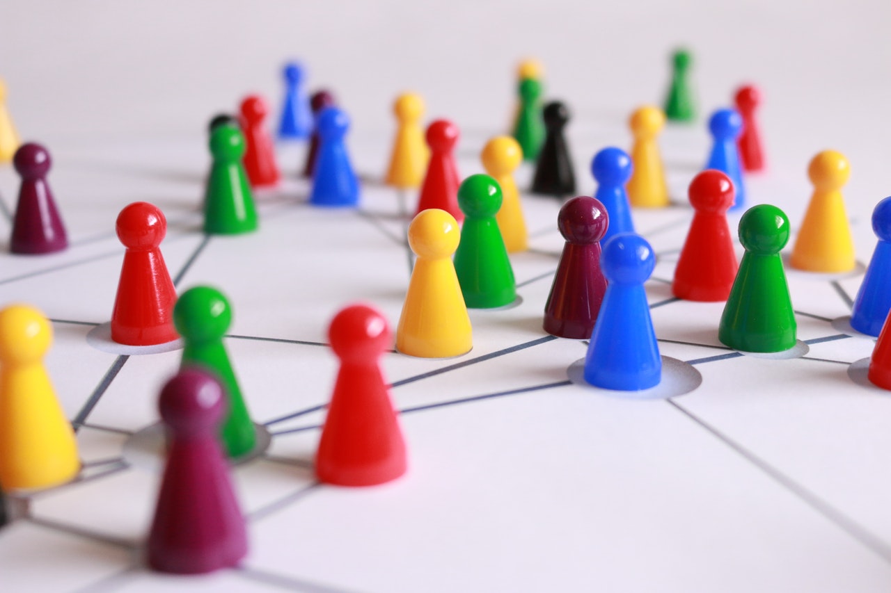 Multi-colored game pieces on a white game board 