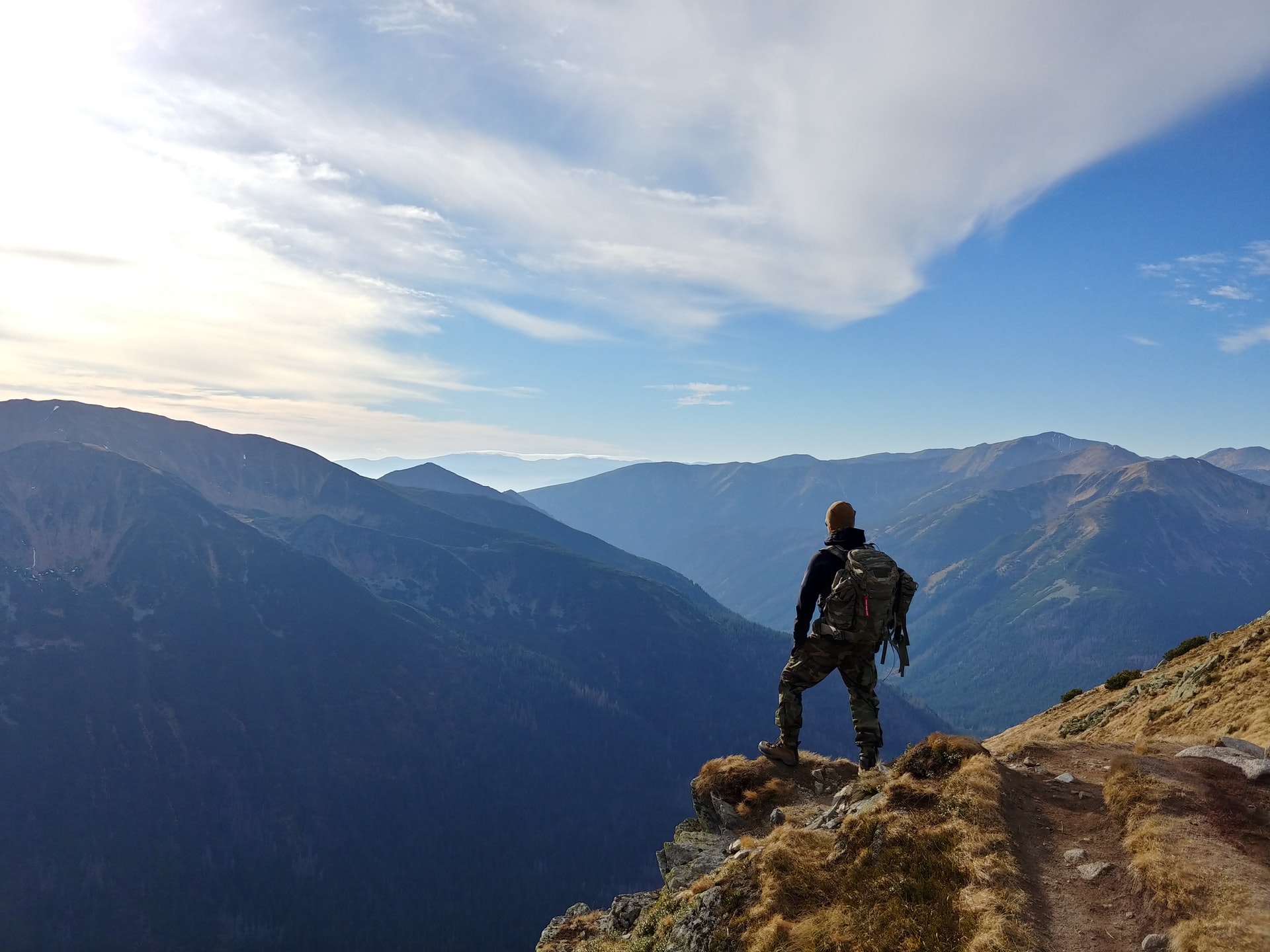 person on a quest overlooking mountains